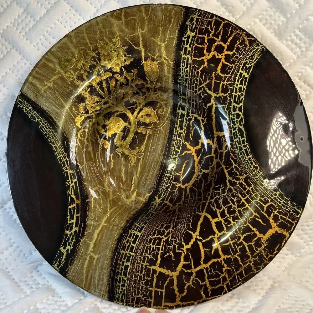 Glass bowl features an asymmetrical shape with a striking black and gold crackle